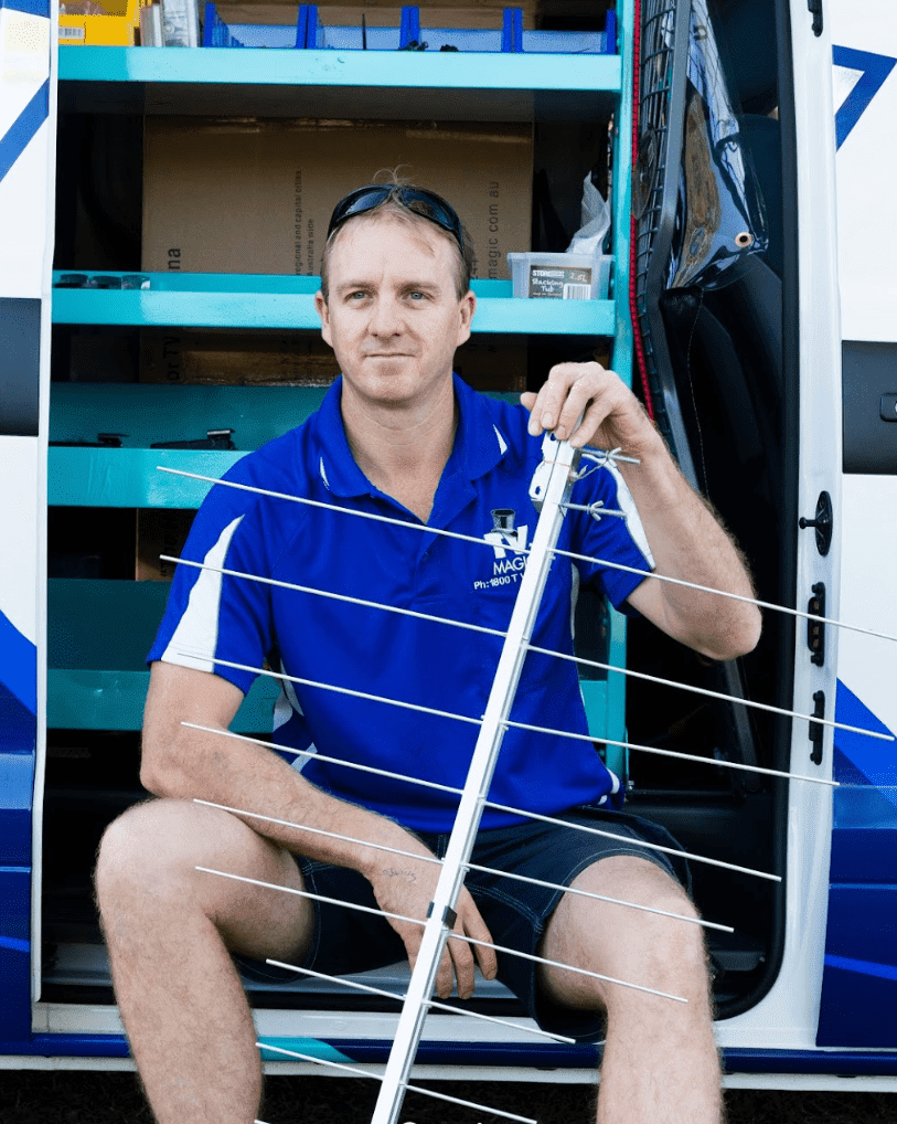 Brent from TV Magic Sunshine Coast with an antenna at his work van